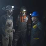 Miners underground with safety equipment on