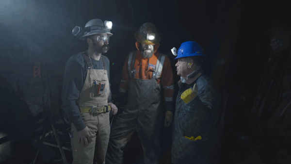 Miners underground with safety equipment on